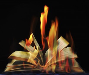 Open book in flame on black background